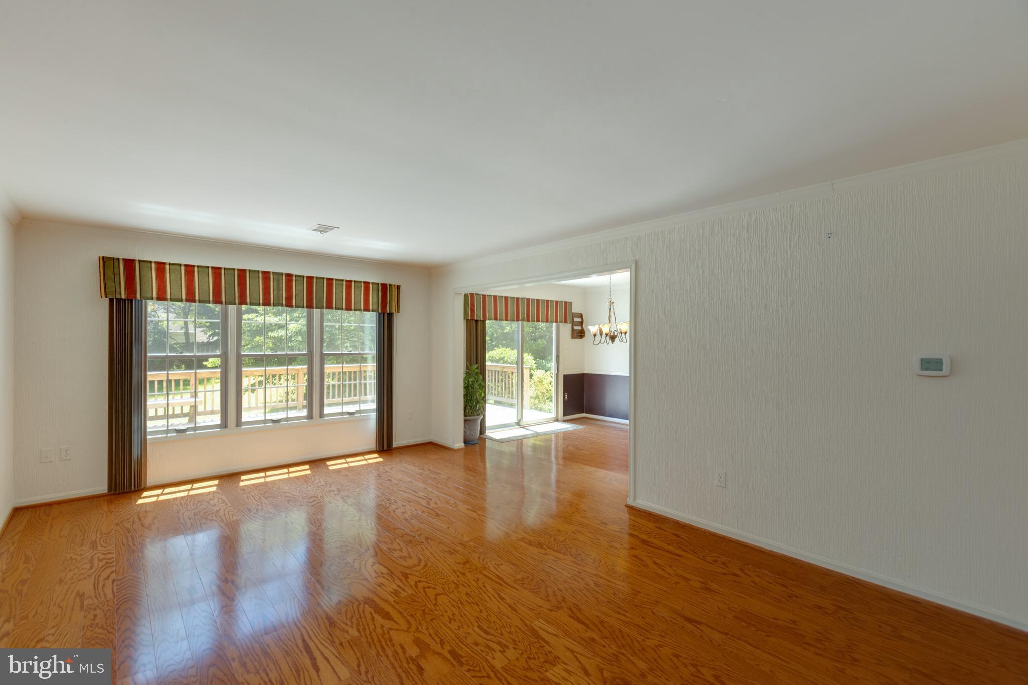 11821 Riders Lane Reston, VA 20191 - Photo 9 of 44 a view of an empty room with a window and wooden floor