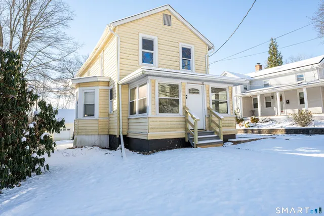 a view of a house with a yard and sitting area