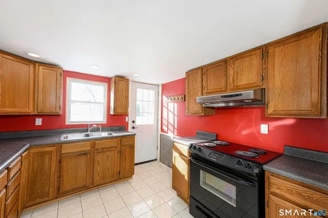 a kitchen with stainless steel appliances a stove sink and cabinets