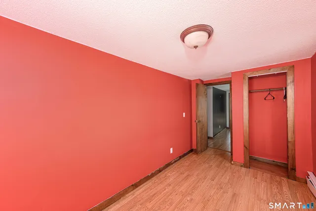 a view of a room with wooden floor and white walls