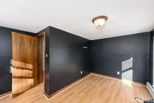 a view of a room with wooden floor and windows