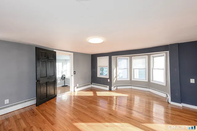 wooden floor in an empty room with a window