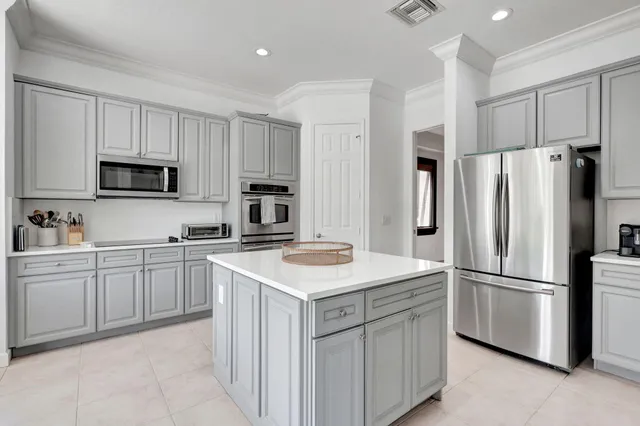 a dining room with furniture a chandelier and a rug