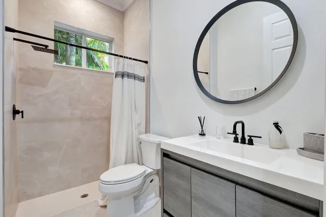 a bathroom with a double vanity sink mirror and bathtub