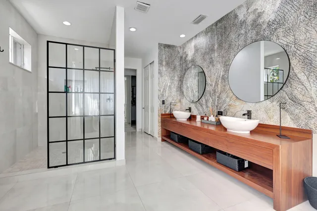 an aerial view of residential houses with outdoor space and trees