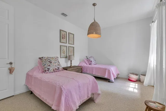 an aerial view of residential houses with outdoor space and trees