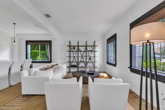 a dining room with furniture entryway and wooden floor