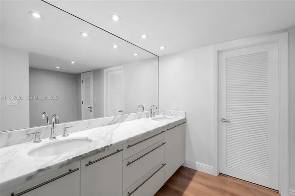 a bathroom with a granite countertop sink double and mirror
