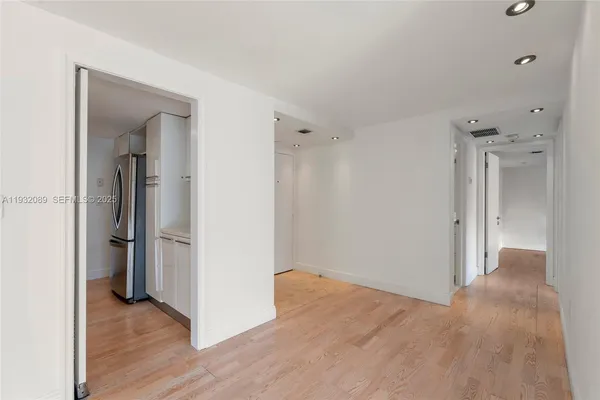 a view of a room with wooden floor