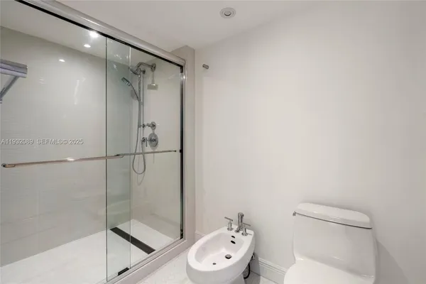 a bathroom with a toilet and a shower