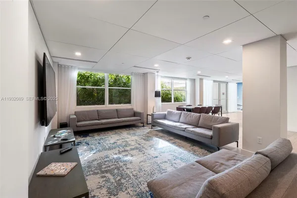a living room with furniture window and a table
