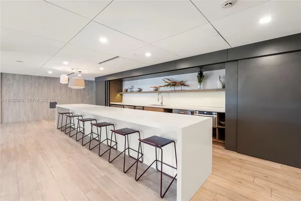 a kitchen with stainless steel appliances a refrigerator and microwave