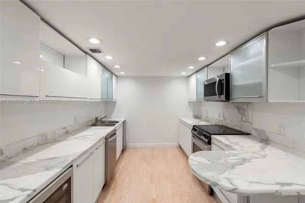 a kitchen with a sink stove and microwave