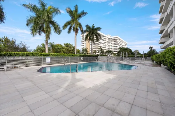 a view of pool with outdoor seating and plants