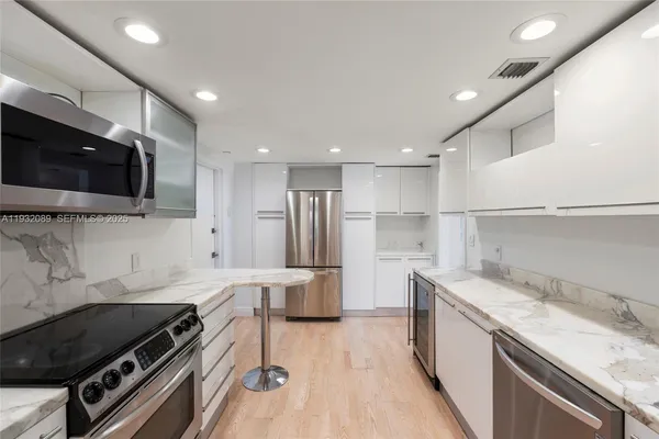 a kitchen with a sink a stove and a refrigerator