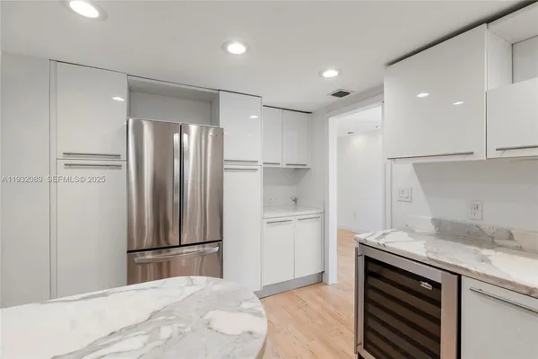 a kitchen with a refrigerator and a sink
