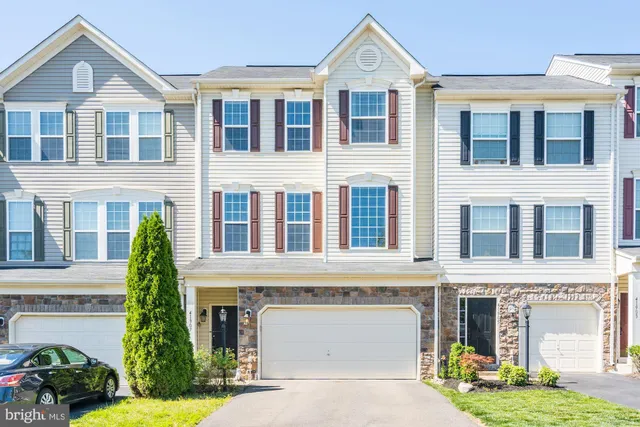 front view of a brick house with a yard