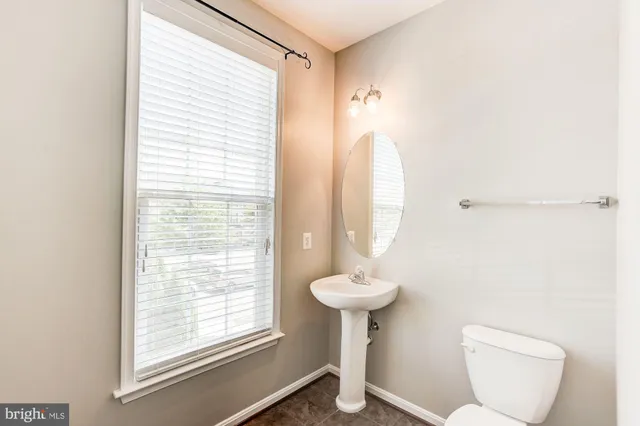 a bathroom with a toilet sink and window