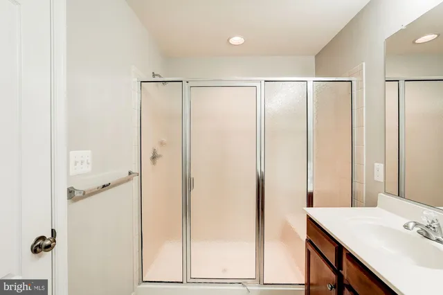 a bathroom with a shower and a sink