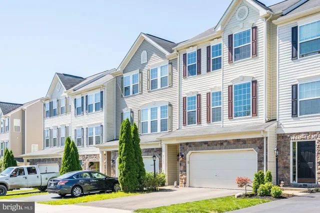 a front view of a residential apartment building with yard