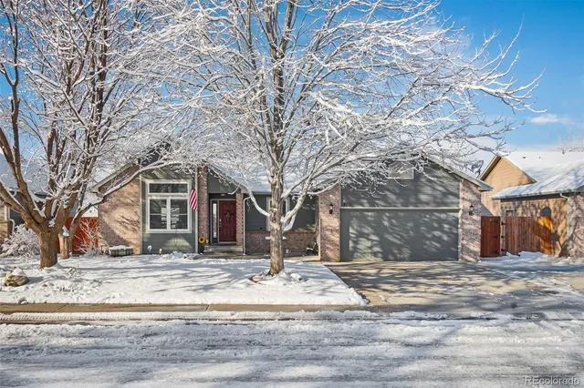 a view of a white house with a snow on the road