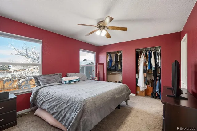 a bedroom with a large bed and a chandelier