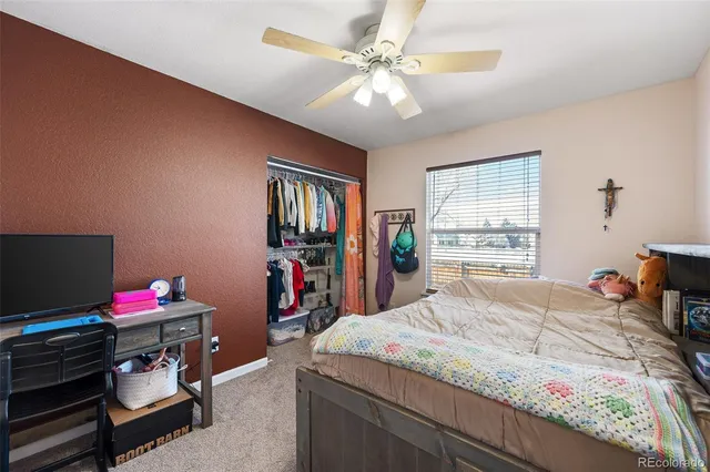 a bedroom with a bed dresser and a window