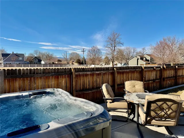 a view of a roof deck with furniture