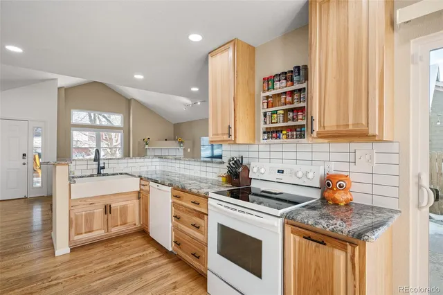 a kitchen with a sink stove and cabinets