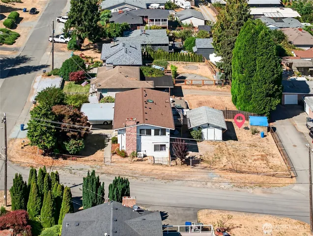 an aerial view of residential houses with outdoor space