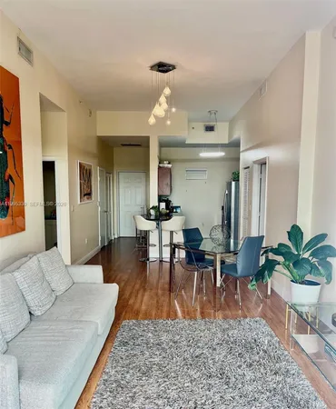 a living room with furniture potted plant and a chandelier