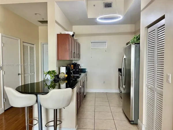a kitchen with a table and chairs