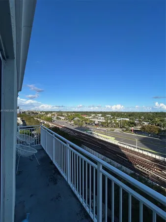 a view of city and ocean from a balcony