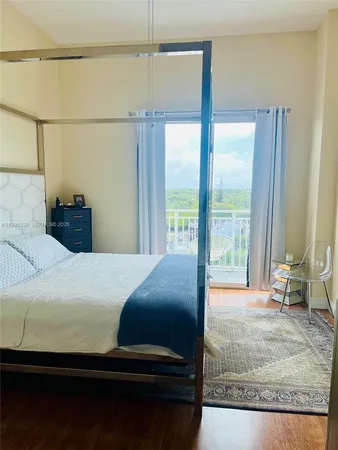 a bedroom with a bed and large window