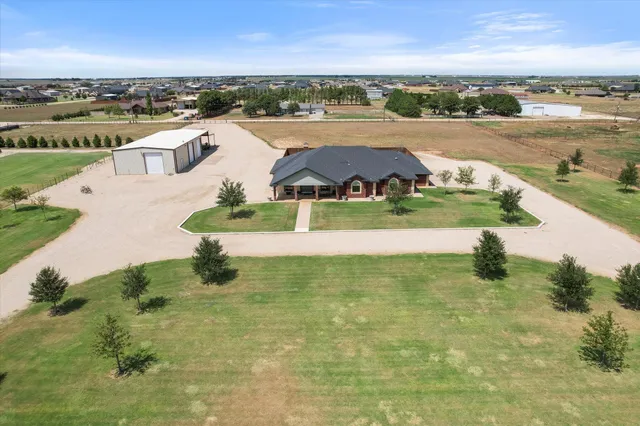 an aerial view of residential houses with outdoor space and river