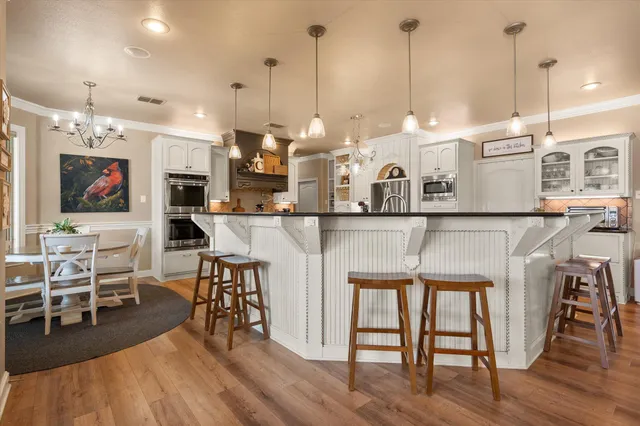a kitchen with stainless steel appliances granite countertop a stove and a cabinets