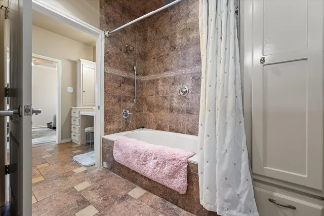 a bedroom with a bed window and a flat screen tv