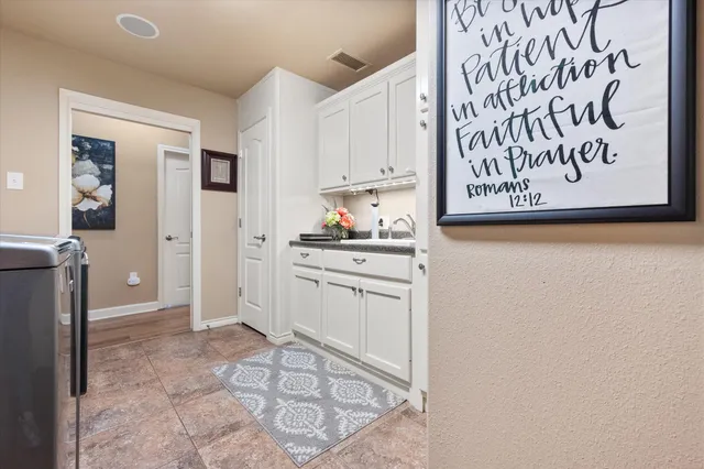 a living room with patio furniture and a floor to ceiling window