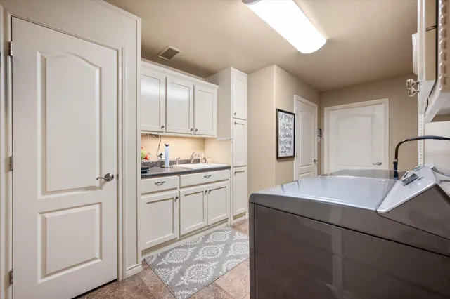 a view of swimming pool with outdoor seating and house in the background