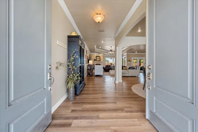 a view of a dining room with furniture wooden floor and chandelier