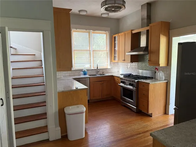 a kitchen with granite countertop a refrigerator and a sink