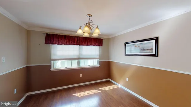 a view of a livingroom with furniture a flat screen tv and floor to ceiling window