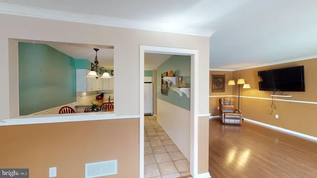 a view of a hallway with white walls and stairs