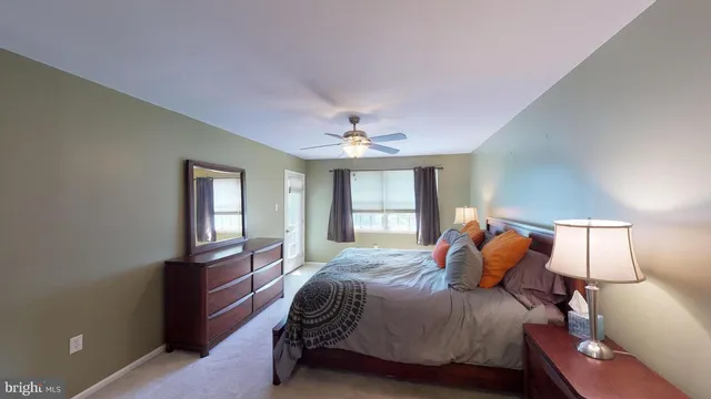 a view of an empty room with a window and a kitchen