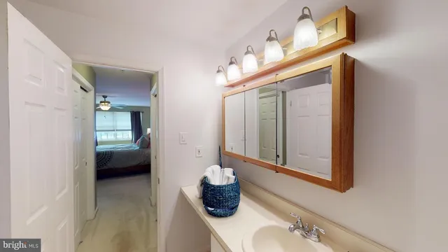 a view of a hallway with bathroom and a bathroom