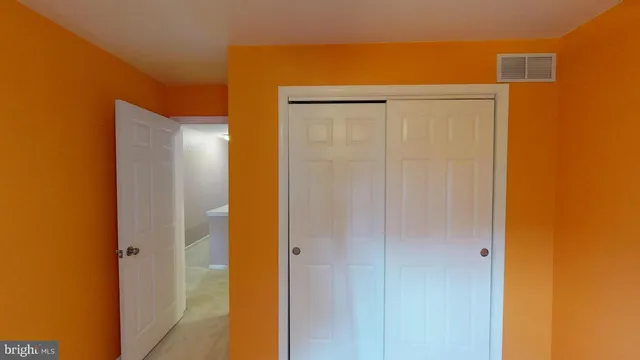 a white toilet sitting next to a bathroom sink and vanity