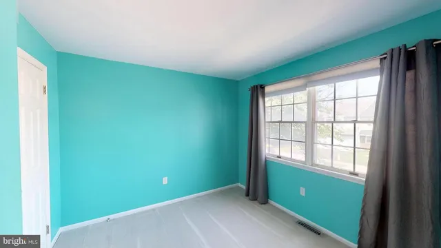 a view of a house with a big yard and large trees