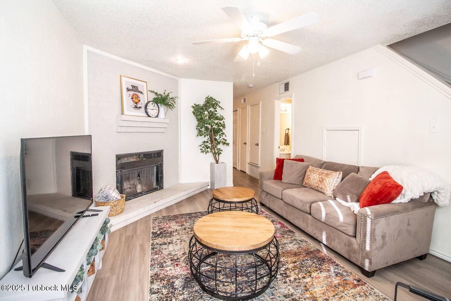 5806 6th Street, Unit B Lubbock, TX 79416 - Photo 3 of 45 a living room with furniture and a fireplace
