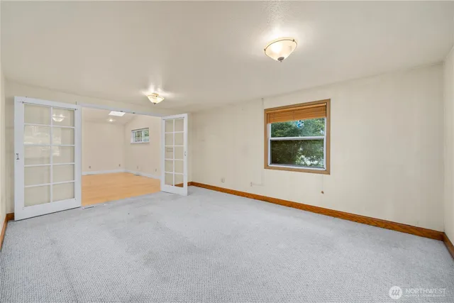 an empty room with a empty space and windows