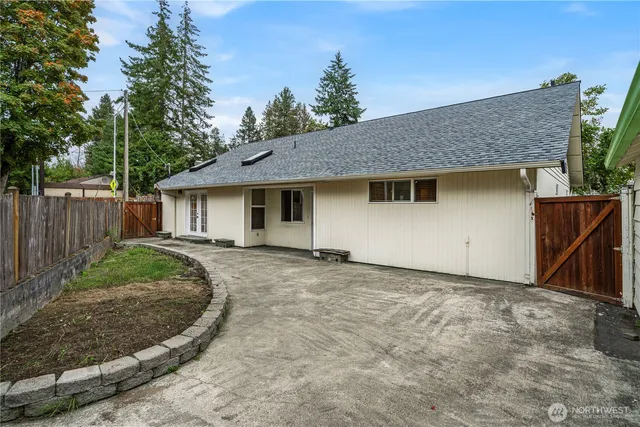 a view of a backyard with wooden fence